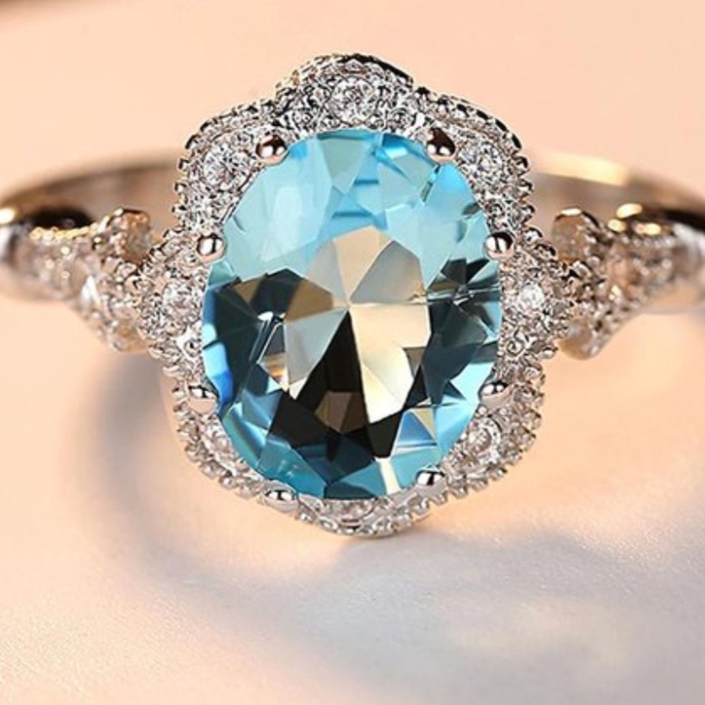 Costume jewelry ring light blue oval CZ